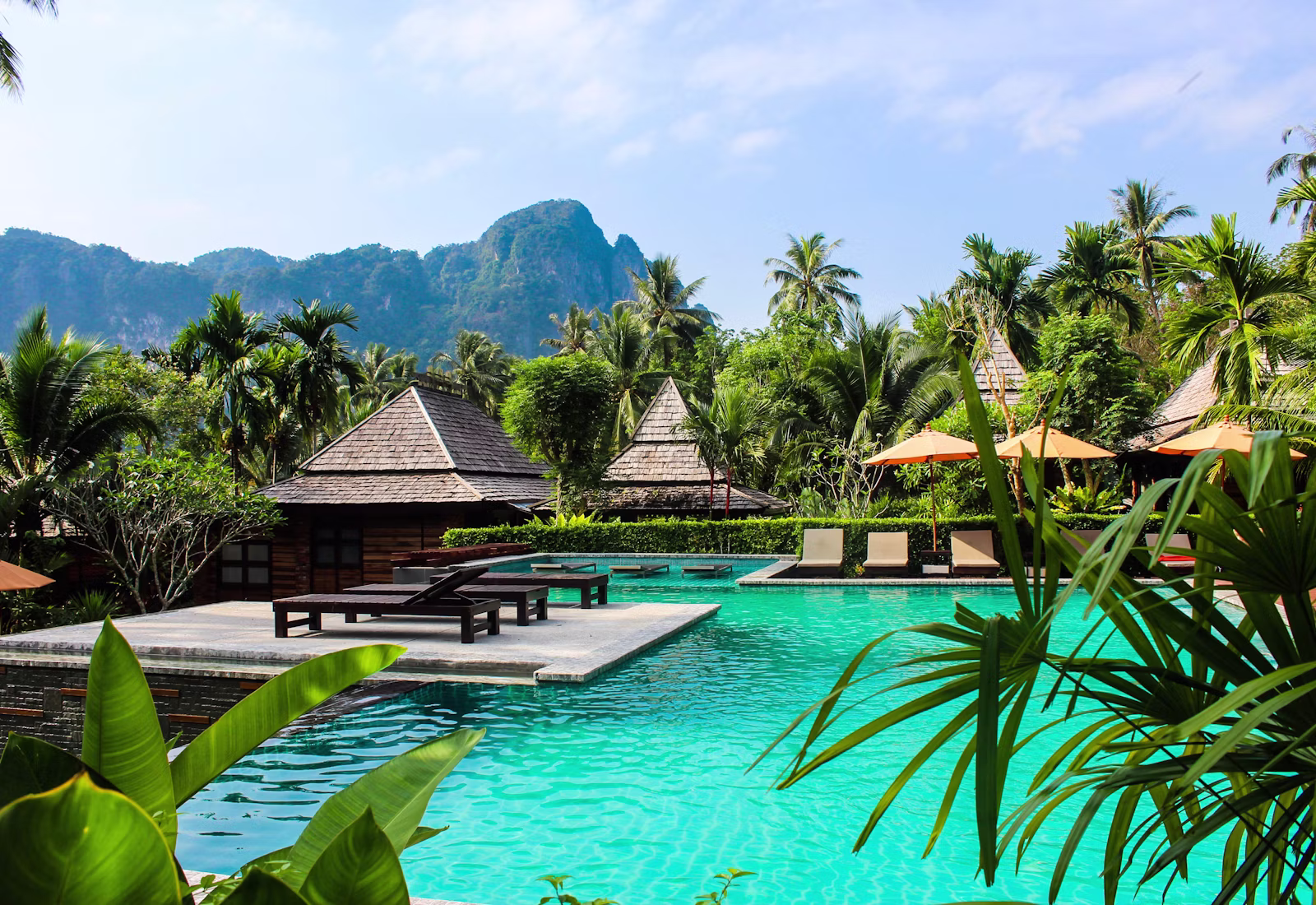 A serene Velvet Crest poolside courtyard surrounded by gardens