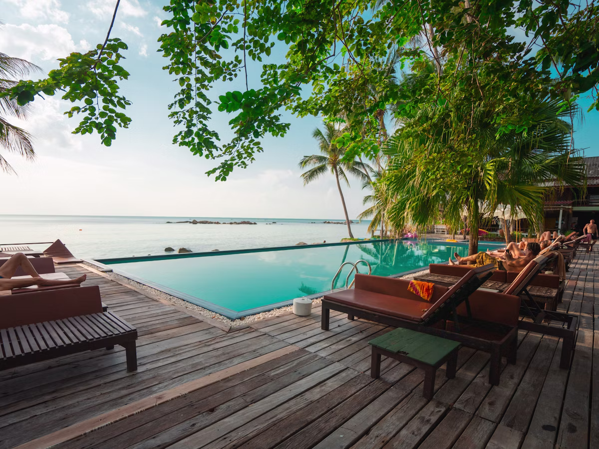 Tranquil poolside terrace framed by palms at sunset