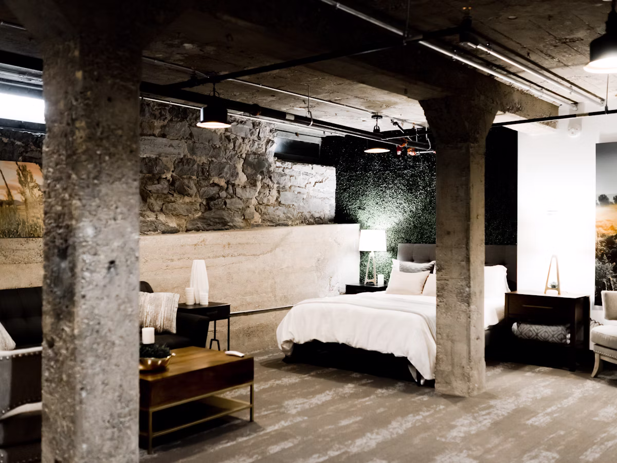 Stylish lounge-style room with feature stone wall and warm lamplight