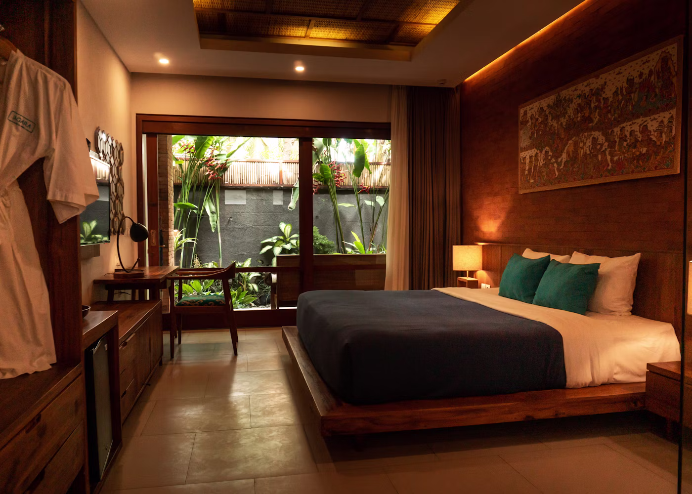 The Velvet Crest Kingsize Deluxe AC room with a plush kingsize bed, warm wood tones and a seating nook