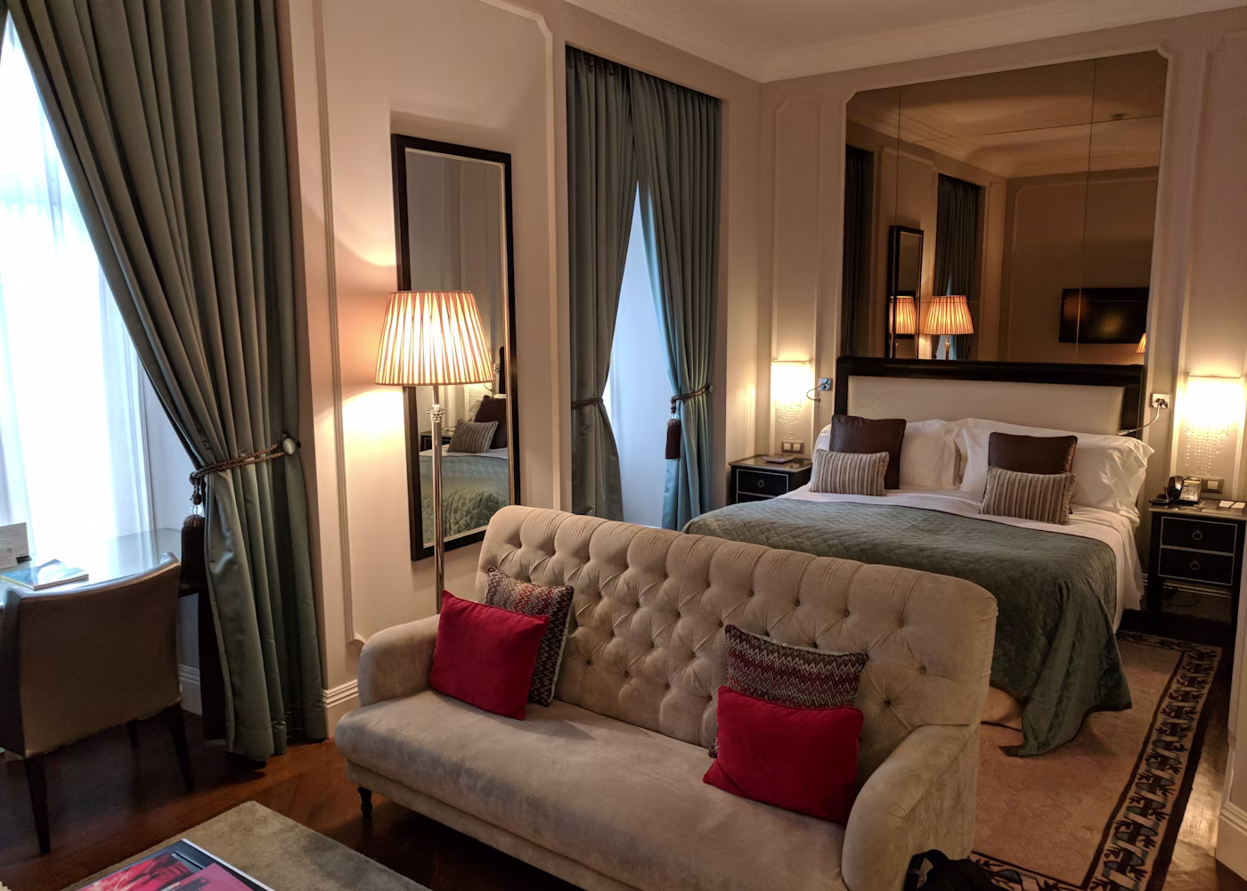 The Velvet Crest Kingsize Suite AC with a plush kingsize bed, separate sitting area and elegant drapery